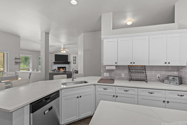 kitchen featuring stainless steel dishwasher, ceiling fan, white cabinetry, and sink