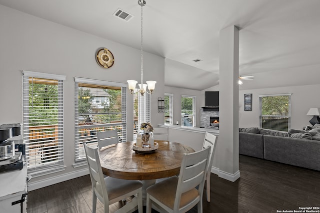 dining room with plenty of natural light, lofted ceiling, and dark wood-type flooring