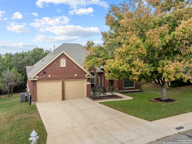 view of front of house with a front yard, cooling unit, and a garage