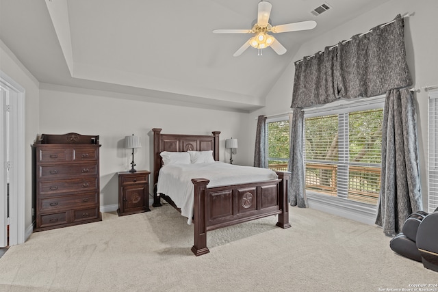 bedroom with light colored carpet, ceiling fan, and vaulted ceiling