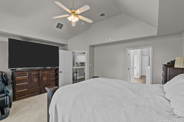 bedroom featuring ceiling fan, connected bathroom, lofted ceiling, and carpet floors