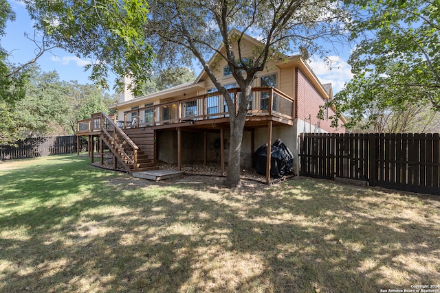 rear view of property with a lawn and a deck