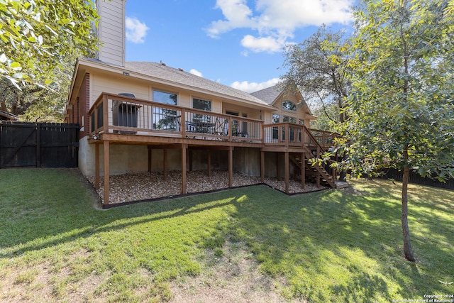 back of property featuring a lawn and a wooden deck