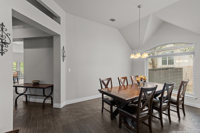 dining area featuring dark hardwood / wood-style flooring, high vaulted ceiling, and an inviting chandelier