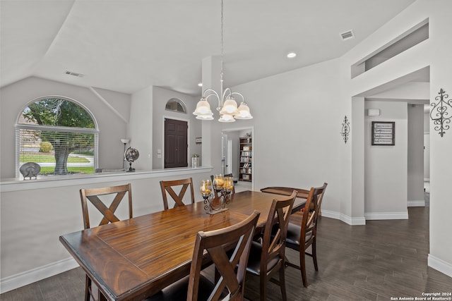 dining area featuring dark hardwood / wood-style flooring, a chandelier, and vaulted ceiling