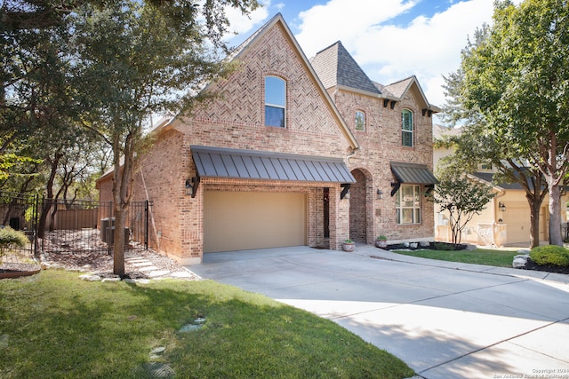 view of front of house with a garage and a front yard