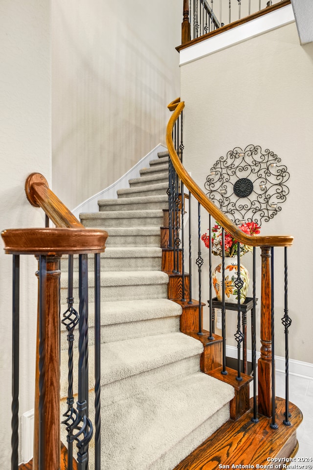 staircase featuring wood-type flooring