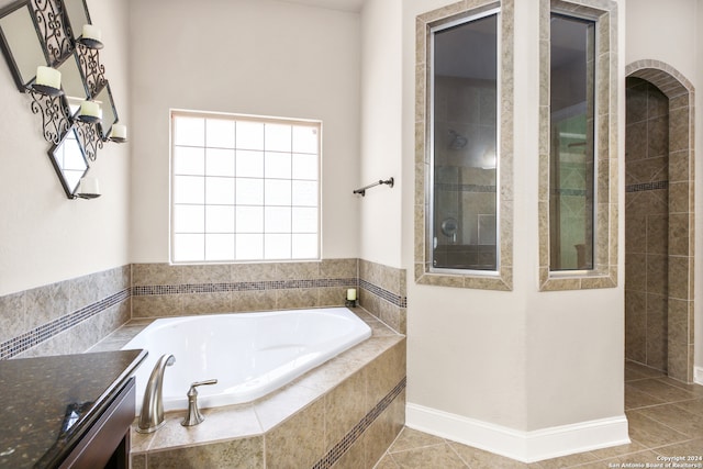 bathroom featuring tile patterned flooring and plus walk in shower