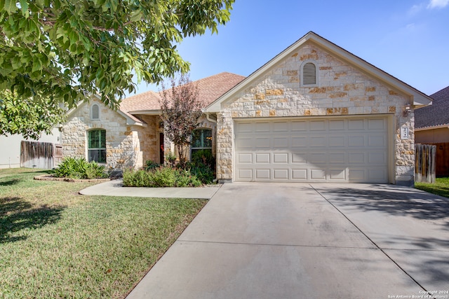 ranch-style house with a garage and a front yard