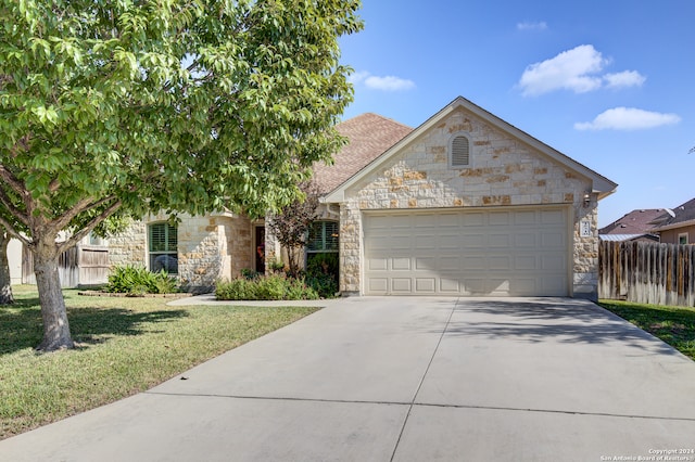 view of front of property with a garage and a front yard