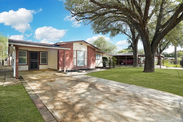 exterior space featuring a yard and a carport