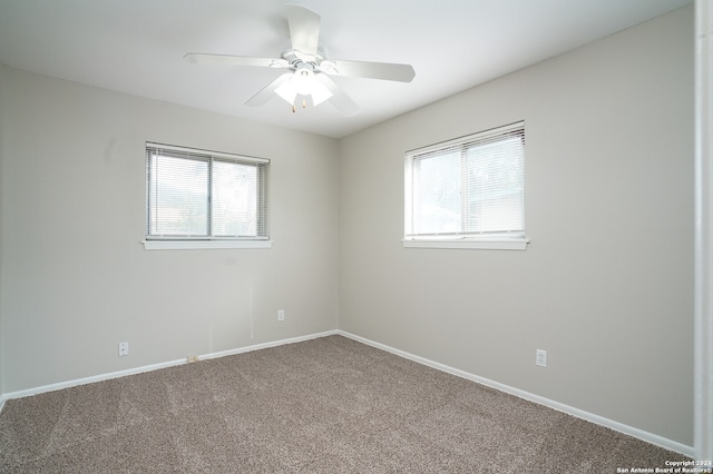 carpeted empty room featuring ceiling fan