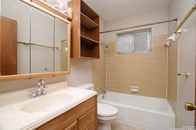 full bathroom featuring vanity, tile patterned flooring, toilet, and tiled shower / bath