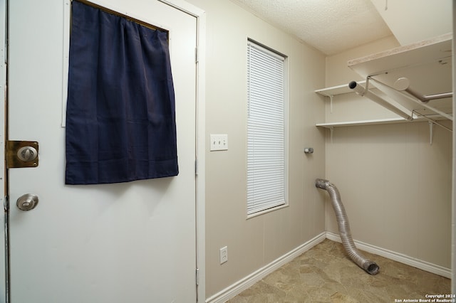 laundry room with a textured ceiling