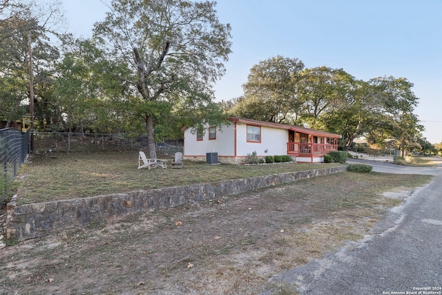 exterior space with central AC unit and a wooden deck