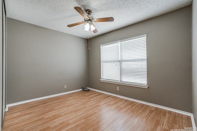 spare room featuring ceiling fan, a textured ceiling, and light wood-type flooring