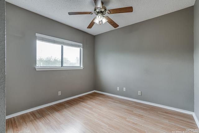 spare room featuring ceiling fan, a textured ceiling, and light wood-type flooring