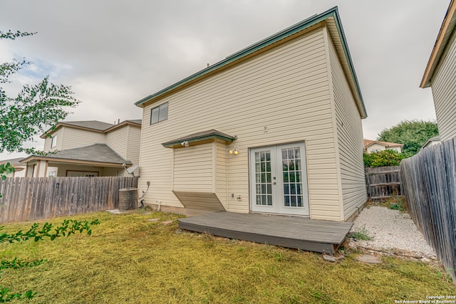 rear view of house with a yard, french doors, and a deck