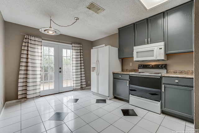 kitchen with gray cabinetry, white appliances, a textured ceiling, and light tile patterned floors