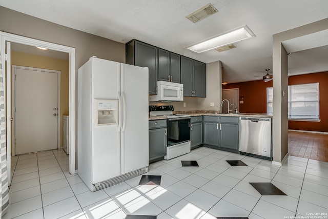 kitchen featuring light tile patterned flooring, sink, ceiling fan, white appliances, and gray cabinetry