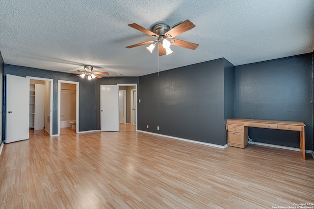 unfurnished room with light wood-type flooring, a textured ceiling, and ceiling fan