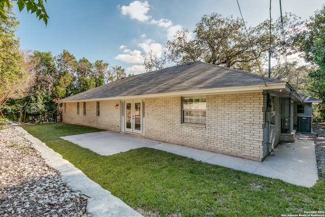 back of house with a yard, a patio, and french doors