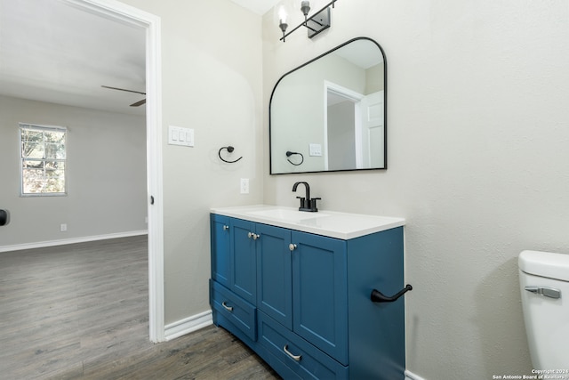 bathroom featuring vanity, hardwood / wood-style flooring, and toilet