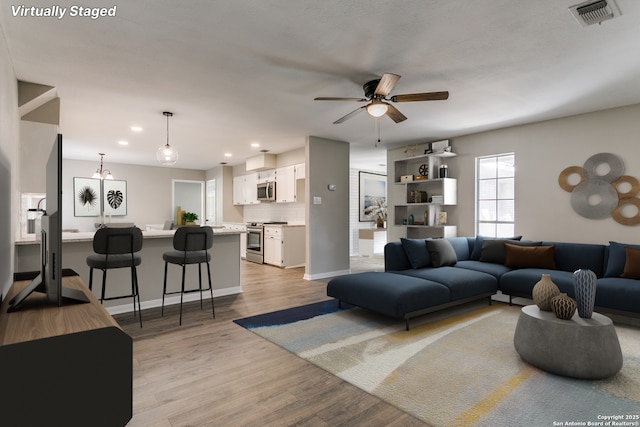 4103 Midvale Dr, San Antonio, TX 78229 - living area with a ceiling fan, recessed lighting, light wood finished floors, and baseboards