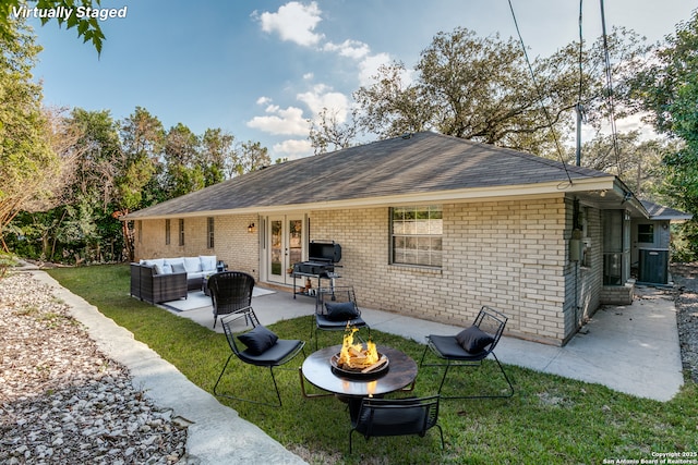 4103 Midvale Dr, San Antonio, TX 78229 - back of property featuring an outdoor living space with a fire pit, french doors, a lawn, a patio, and brick siding