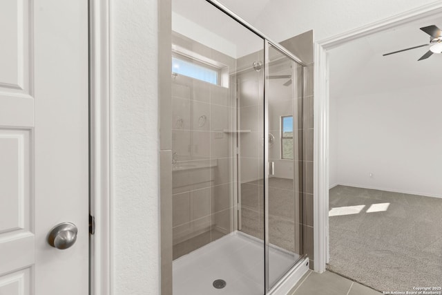 bathroom with ceiling fan and a shower with shower door