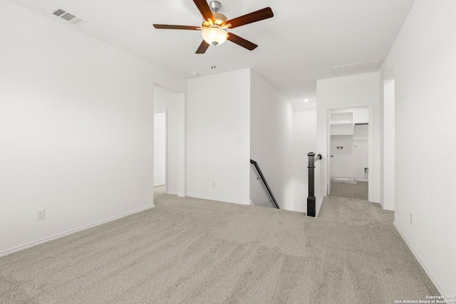 carpeted empty room featuring ceiling fan