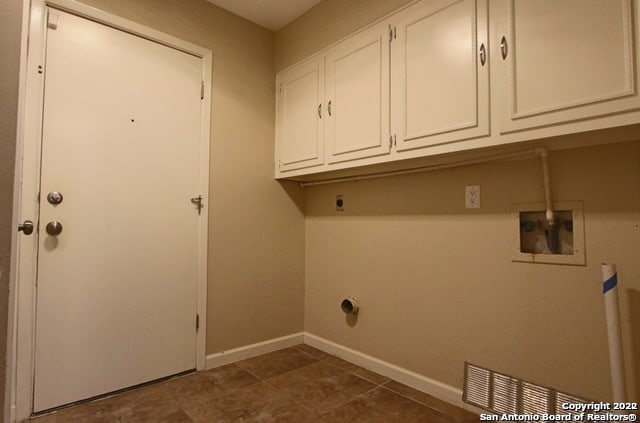 laundry room featuring cabinets, hookup for a washing machine, and electric dryer hookup