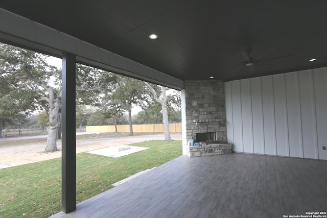 view of patio / terrace with an outdoor stone fireplace and a deck