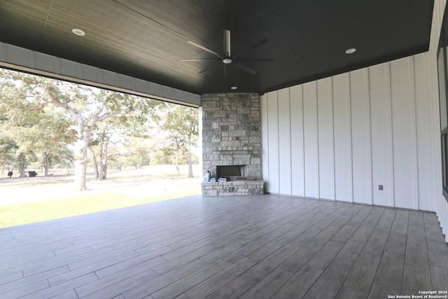 view of patio with an outdoor stone fireplace and ceiling fan