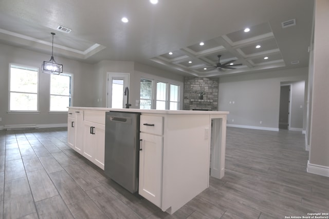 kitchen featuring white cabinetry, stainless steel dishwasher, an island with sink, decorative light fixtures, and hardwood / wood-style flooring