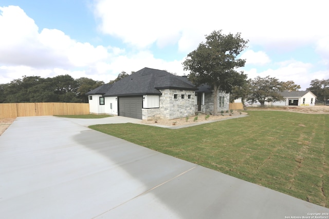 view of side of home with a lawn and a garage