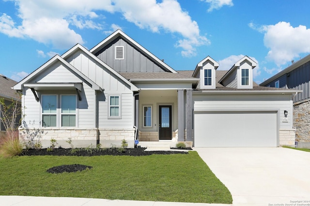 11514 Hollering Pass, Schertz, TX 78154 - view of front facade with board and batten siding, an attached garage, driveway, a front yard, and stone siding