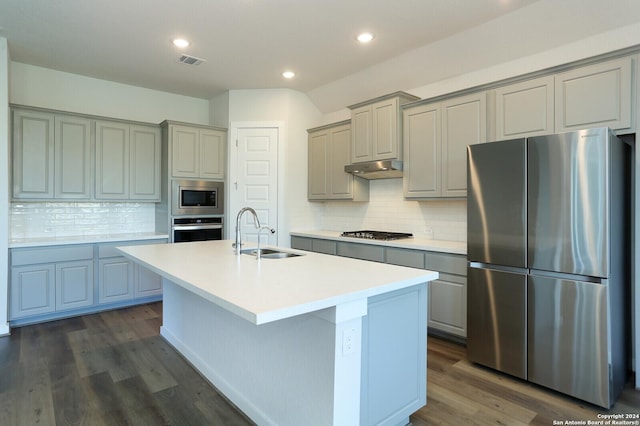11514 Hollering Pass, Schertz, TX 78154 - kitchen with appliances with stainless steel finishes, a sink, gray cabinets, a center island with sink, and dark wood-style flooring
