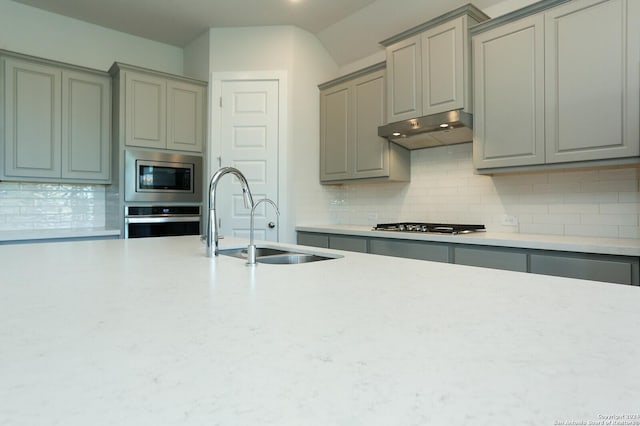 11514 Hollering Pass, Schertz, TX 78154 - kitchen with stainless steel appliances, gray cabinetry, under cabinet range hood, and light countertops