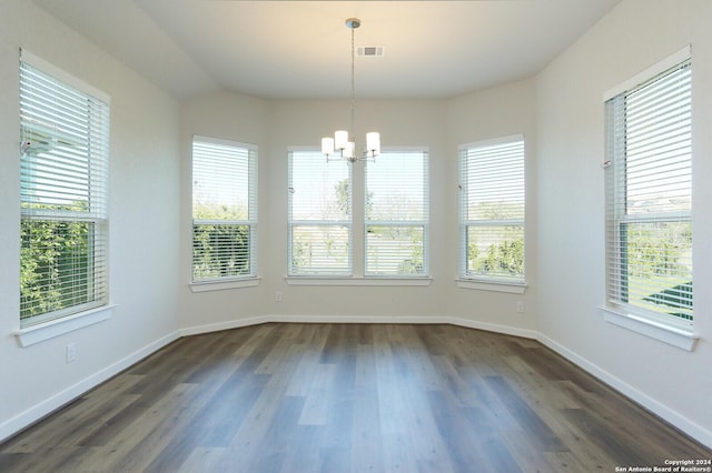 11514 Hollering Pass, Schertz, TX 78154 - unfurnished dining area with a chandelier, plenty of natural light, and dark wood-style floors