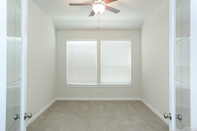 11514 Hollering Pass, Schertz, TX 78154 - spare room featuring french doors, light colored carpet, a ceiling fan, and baseboards