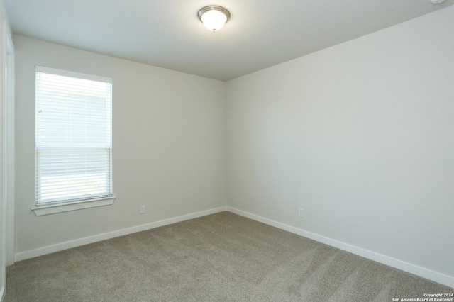 11514 Hollering Pass, Schertz, TX 78154 - empty room featuring carpet, baseboards, and plenty of natural light