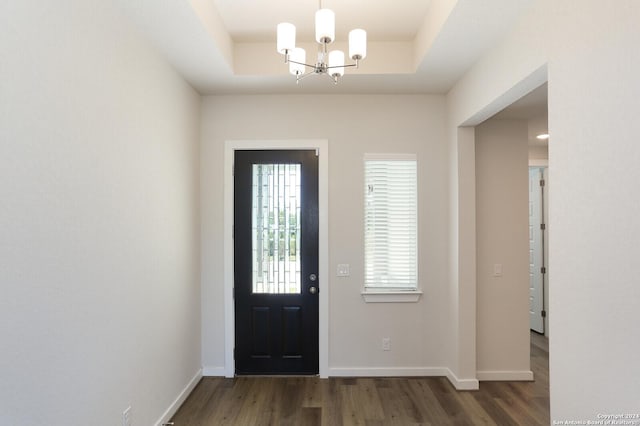 11514 Hollering Pass, Schertz, TX 78154 - entryway with wood finished floors, a chandelier, a tray ceiling, and baseboards