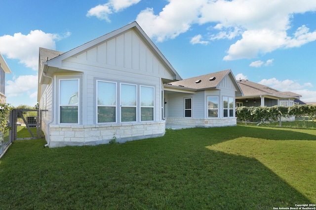 11514 Hollering Pass, Schertz, TX 78154 - rear view of property with board and batten siding and a shingled roof