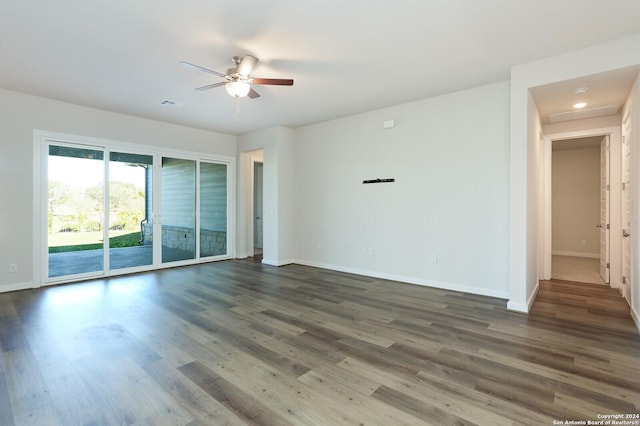 11514 Hollering Pass, Schertz, TX 78154 - spare room with baseboards, a ceiling fan, dark wood-type flooring, and attic access