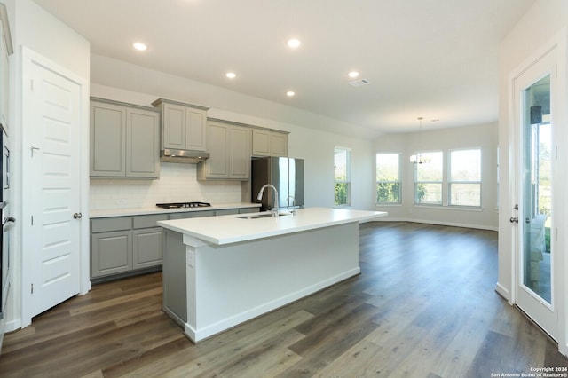 11514 Hollering Pass, Schertz, TX 78154 - kitchen featuring gray cabinetry, a sink, gas stovetop, freestanding refrigerator, and under cabinet range hood