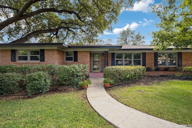 ranch-style house with a front lawn