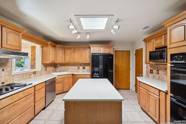 kitchen featuring a center island, sink, tasteful backsplash, track lighting, and black appliances