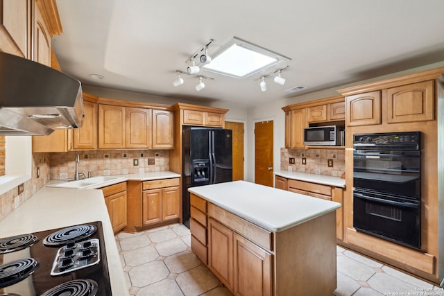 kitchen featuring black appliances, sink, backsplash, and extractor fan