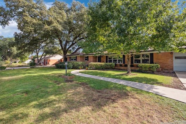 ranch-style home with a front yard and a garage